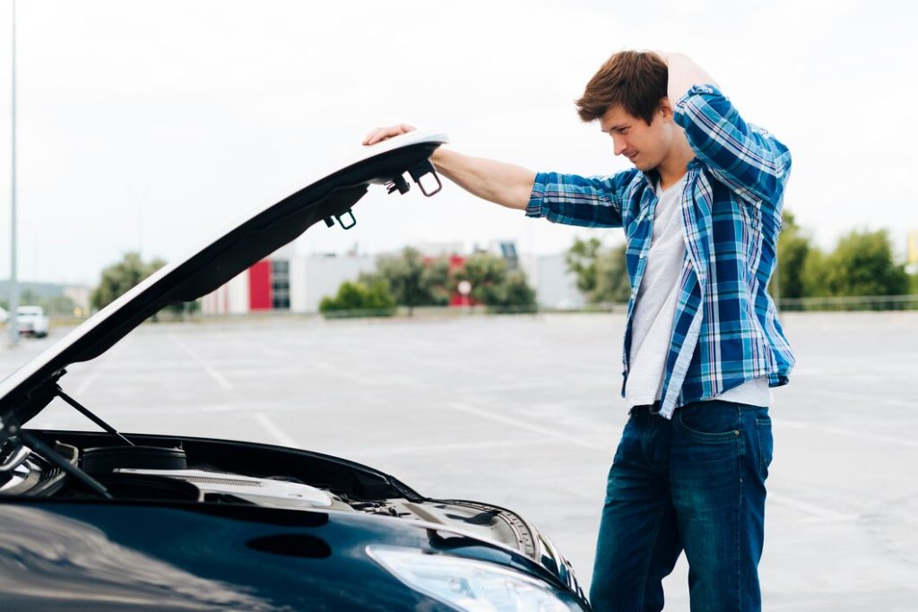side-view-man-checking-engine