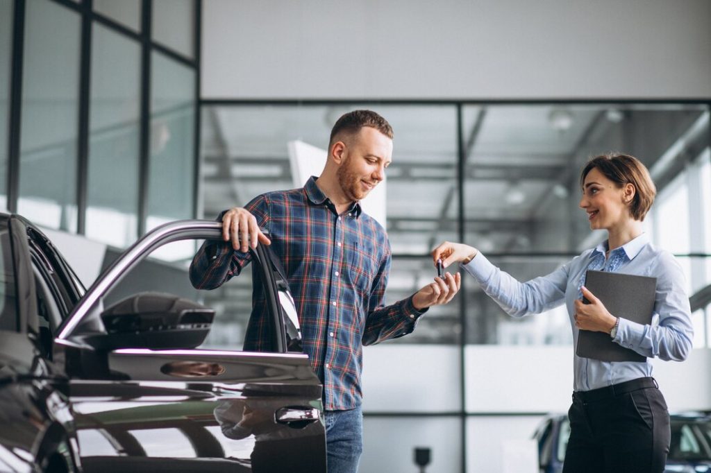 young-handsome-man-choosing-car-car-showroom